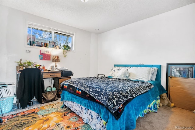 bedroom with carpet floors and a textured ceiling