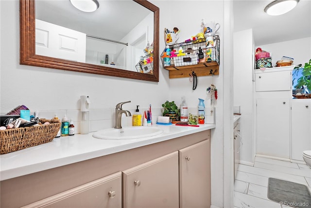 bathroom with vanity and toilet