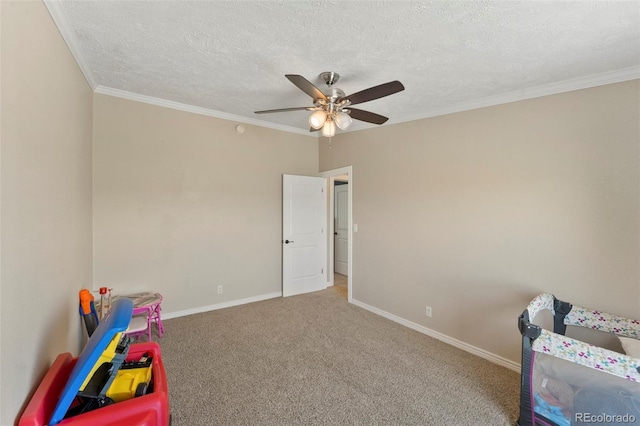 39245 Big Springs Rd, Rush, CO 80833 - playroom with carpet flooring, crown molding, a textured ceiling, and baseboards