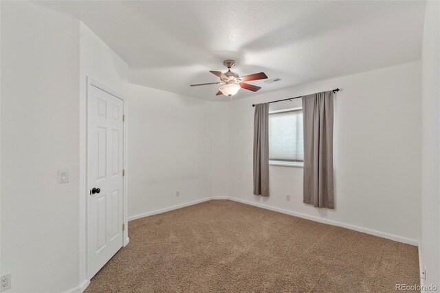 39245 Big Springs Rd, Rush, CO 80833 - carpeted empty room with baseboards, visible vents, and a ceiling fan