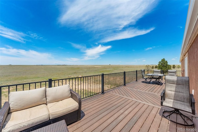 39245 Big Springs Rd, Rush, CO 80833 - deck featuring outdoor dining area, a rural view, and an outdoor living space