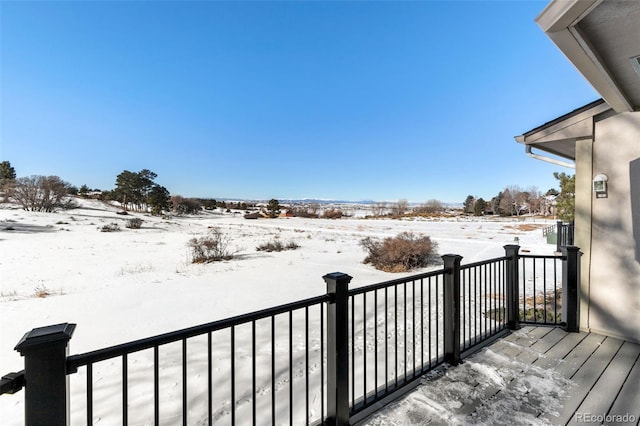 view of snow covered back of property