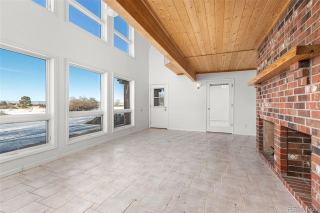 unfurnished living room featuring a fireplace and wooden ceiling