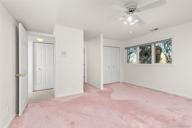 unfurnished bedroom featuring light colored carpet and ceiling fan