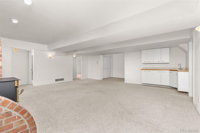 unfurnished living room featuring light colored carpet