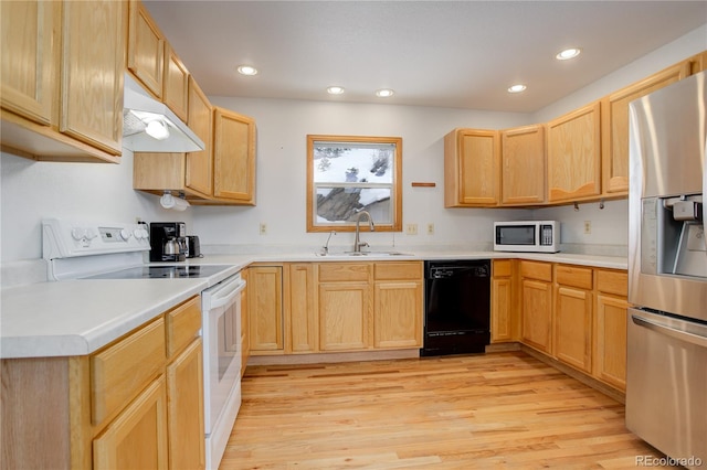 kitchen featuring light brown cabinetry, light hardwood / wood-style floors, white appliances, and sink