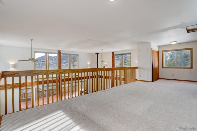 carpeted spare room featuring ceiling fan