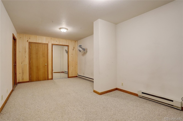 unfurnished bedroom with a closet, light carpet, and baseboard heating