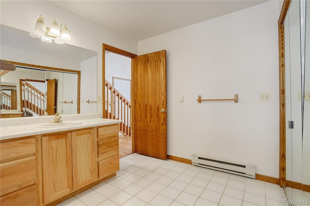 bathroom with tile floors, vanity, and a baseboard radiator