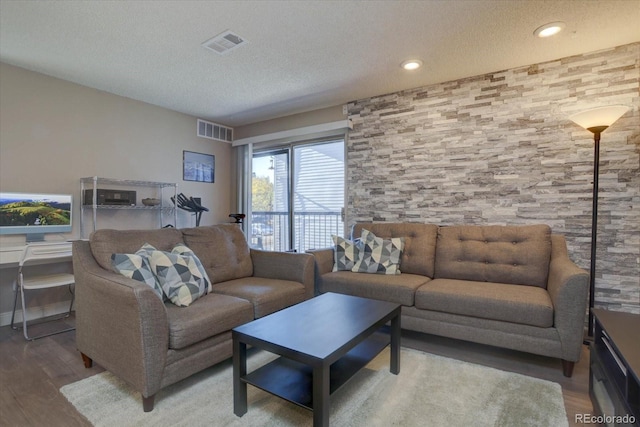 living room featuring hardwood / wood-style floors and a textured ceiling