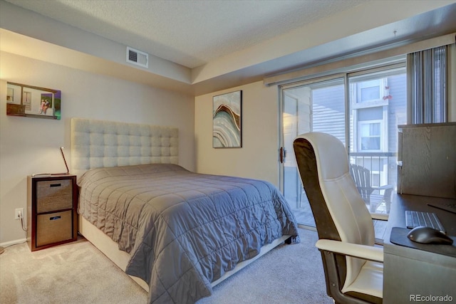 carpeted bedroom featuring a textured ceiling