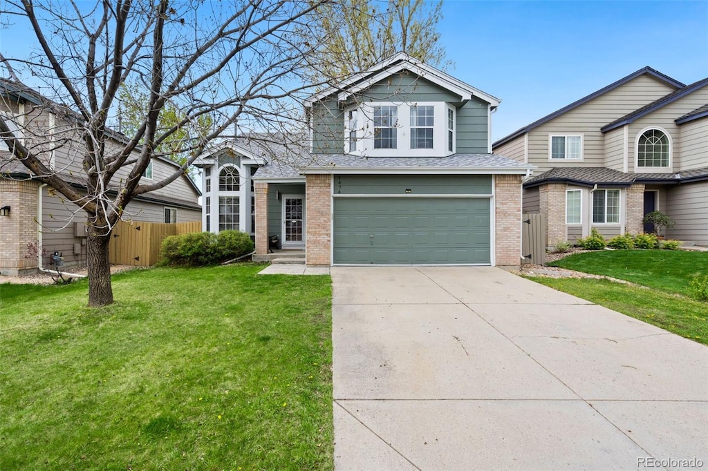1474 E Weldona Way, Superior, CO 80027 - traditional-style home featuring fence, an attached garage, a front lawn, brick siding, and concrete driveway