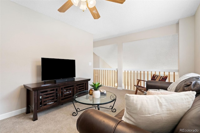 carpeted living room with ceiling fan and baseboards