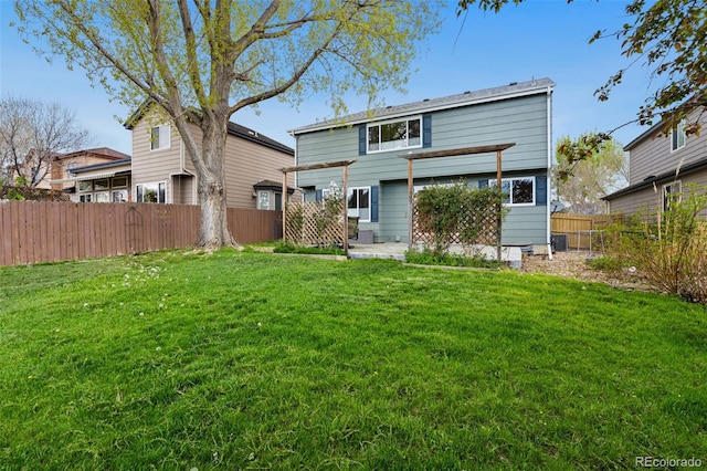 back of house featuring fence and a yard