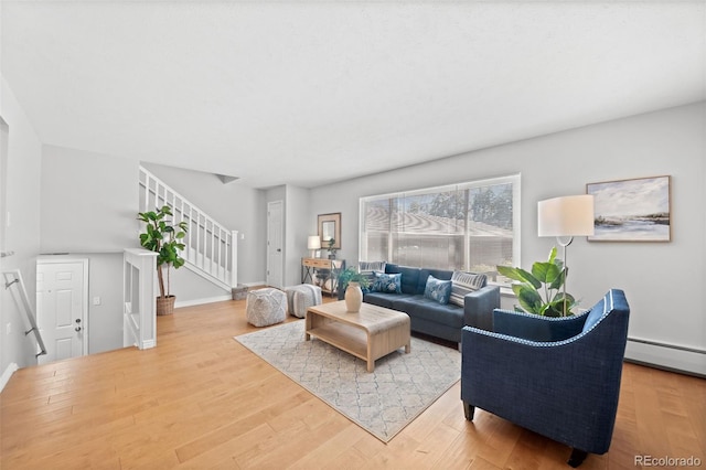 12820 Willow Ln Unit 9, Golden, CO 80401 - living area featuring stairs, light wood-style floors, and baseboard heating
