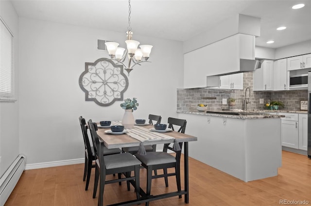 12820 Willow Ln Unit 9, Golden, CO 80401 - dining area with a baseboard radiator, light wood-type flooring, recessed lighting, and a chandelier