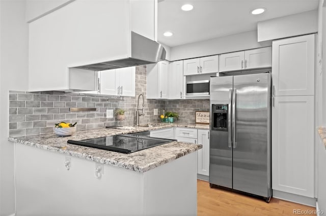 12820 Willow Ln Unit 9, Golden, CO 80401 - kitchen with stainless steel refrigerator with ice dispenser, white cabinetry, a peninsula, light stone counters, and light wood-style flooring