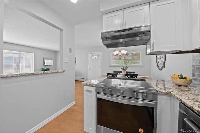 12820 Willow Ln Unit 9, Golden, CO 80401 - kitchen featuring appliances with stainless steel finishes, under cabinet range hood, baseboard heating, white cabinets, and light stone countertops