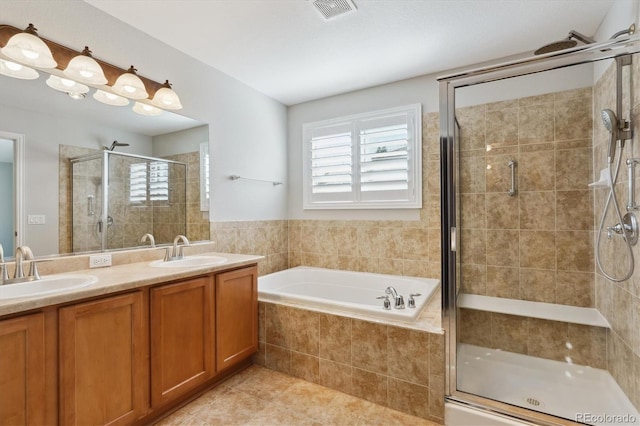 bathroom with vanity, independent shower and bath, and tile patterned flooring