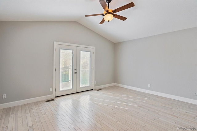 spare room featuring lofted ceiling, french doors, light hardwood / wood-style flooring, and ceiling fan