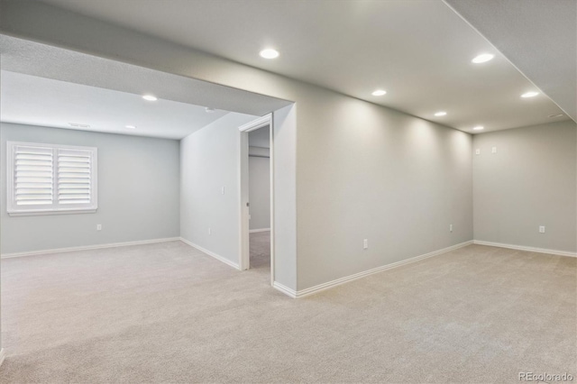 basement featuring light colored carpet