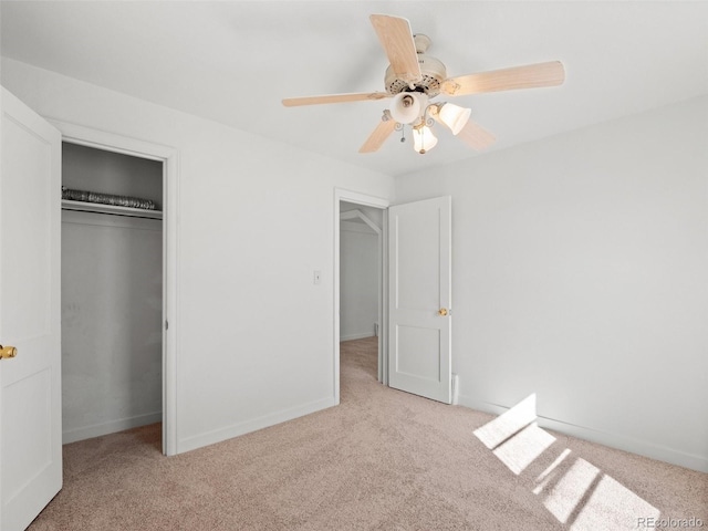 unfurnished bedroom with a ceiling fan, carpet, baseboards, and a closet