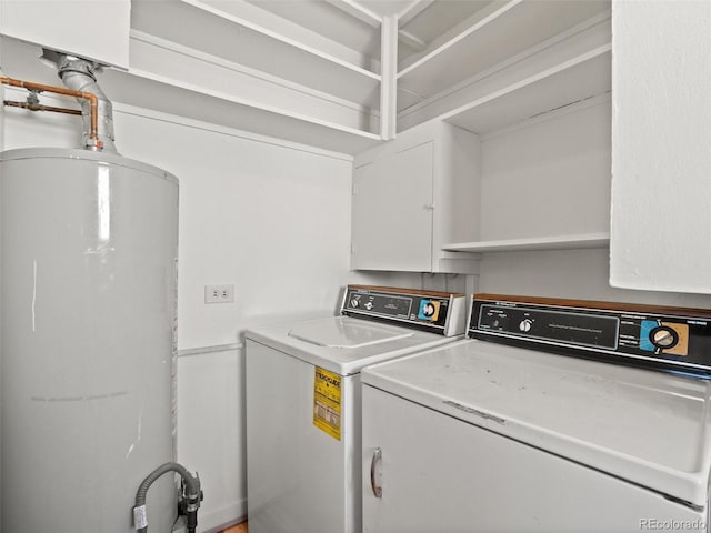 washroom with water heater, laundry area, and independent washer and dryer