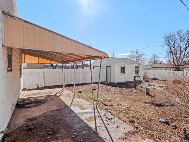 view of yard featuring a fenced backyard, a patio, and an outdoor structure