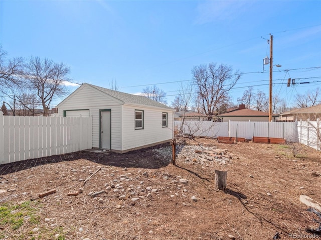 exterior space featuring a fenced backyard and an outdoor structure