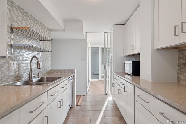 740 N Pearl St Unit 606, Denver, CO 80203 - kitchen featuring appliances with stainless steel finishes, tasteful backsplash, open shelves, white cabinets, and light tile patterned floors