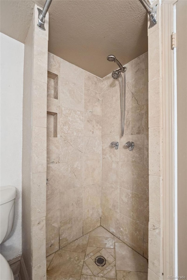 740 N Pearl St Unit 606, Denver, CO 80203 - full bath with a tile shower and a textured ceiling