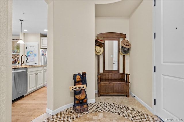 hallway with sink and light tile patterned floors