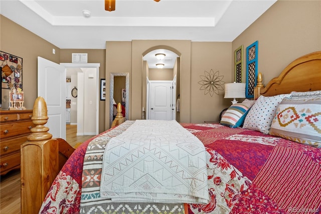 bedroom with ceiling fan and light hardwood / wood-style floors