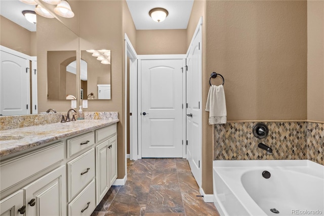 bathroom with vanity and a bath