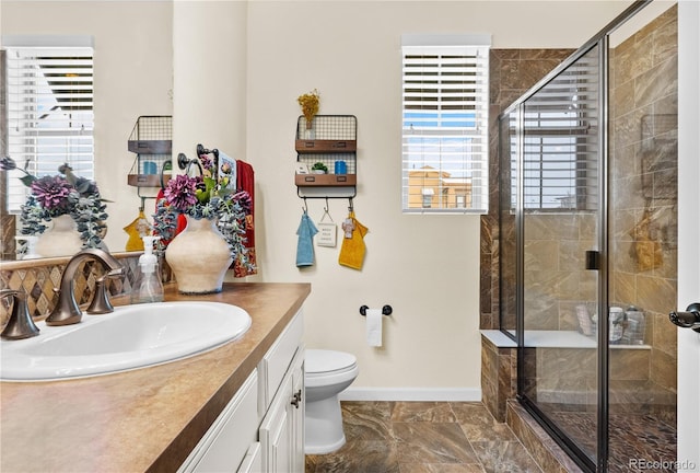 bathroom featuring walk in shower, vanity, and toilet