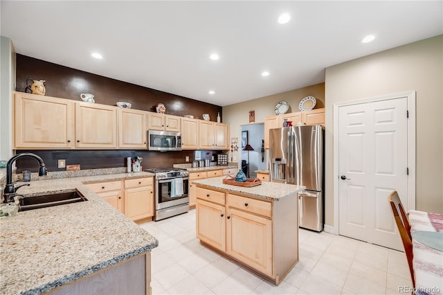 22428 Quail Run Ln, Parker, CO 80138 - kitchen with appliances with stainless steel finishes, light brown cabinetry, a sink, light stone counters, and recessed lighting