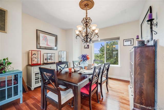 22428 Quail Run Ln, Parker, CO 80138 - dining space with a chandelier, wood finished floors, and baseboards
