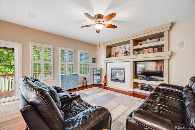 22428 Quail Run Ln, Parker, CO 80138 - living area with ceiling fan, a fireplace, wood finished floors, and baseboards