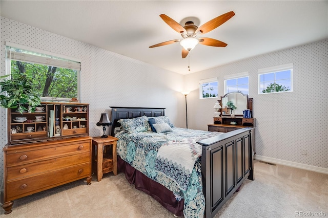 22428 Quail Run Ln, Parker, CO 80138 - bedroom with wallpapered walls, light carpet, multiple windows, baseboards, and ceiling fan