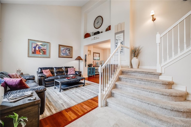 22428 Quail Run Ln, Parker, CO 80138 - living room featuring stairs, a towering ceiling, and wood finished floors