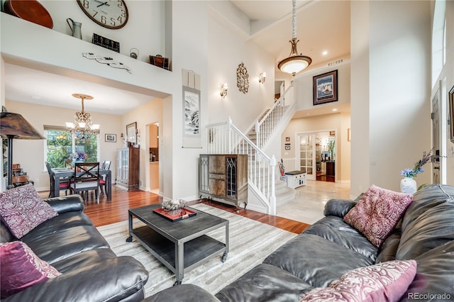 22428 Quail Run Ln, Parker, CO 80138 - living room with stairs, a high ceiling, a chandelier, wood finished floors, and baseboards
