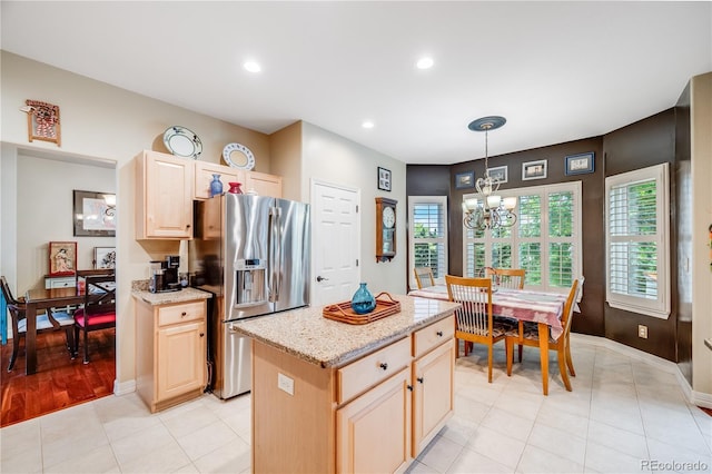 22428 Quail Run Ln, Parker, CO 80138 - kitchen with stainless steel fridge with ice dispenser, a chandelier, light brown cabinetry, recessed lighting, and light stone countertops