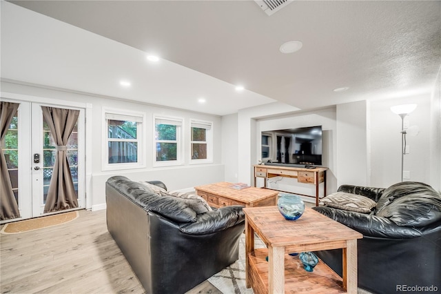 22428 Quail Run Ln, Parker, CO 80138 - living room featuring light wood-style floors, plenty of natural light, recessed lighting, and french doors