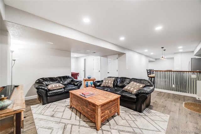 22428 Quail Run Ln, Parker, CO 80138 - living area with light wood-type flooring, a bar, recessed lighting, and baseboards