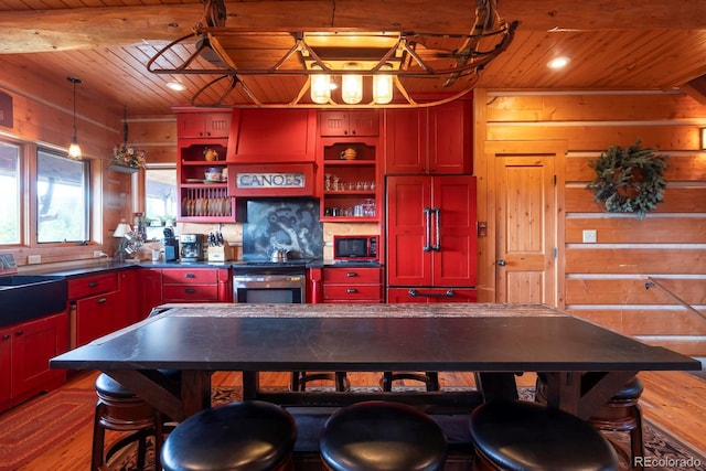 kitchen featuring wood ceiling, red cabinets, open shelves, and built in appliances