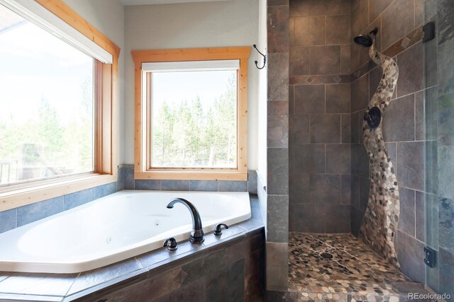 bathroom featuring tiled shower and a garden tub