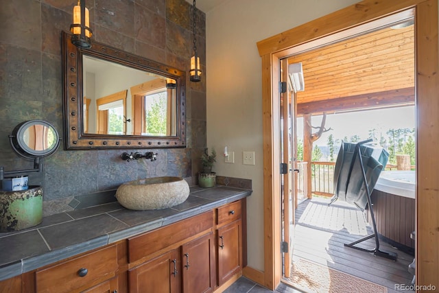 bathroom featuring vanity, decorative backsplash, and hardwood / wood-style flooring