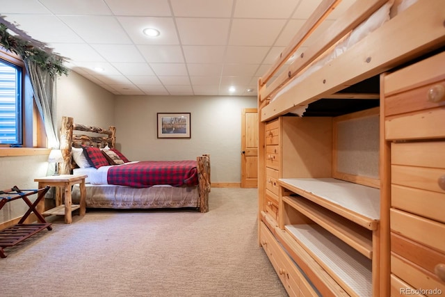 carpeted bedroom featuring a paneled ceiling