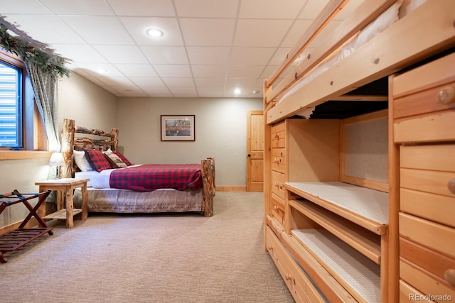 bedroom with a drop ceiling, recessed lighting, and light colored carpet