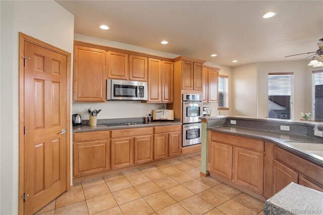 12754 Angelina Dr, Peyton, CO 80831 - kitchen with appliances with stainless steel finishes, dark countertops, recessed lighting, a ceiling fan, and light tile patterned flooring